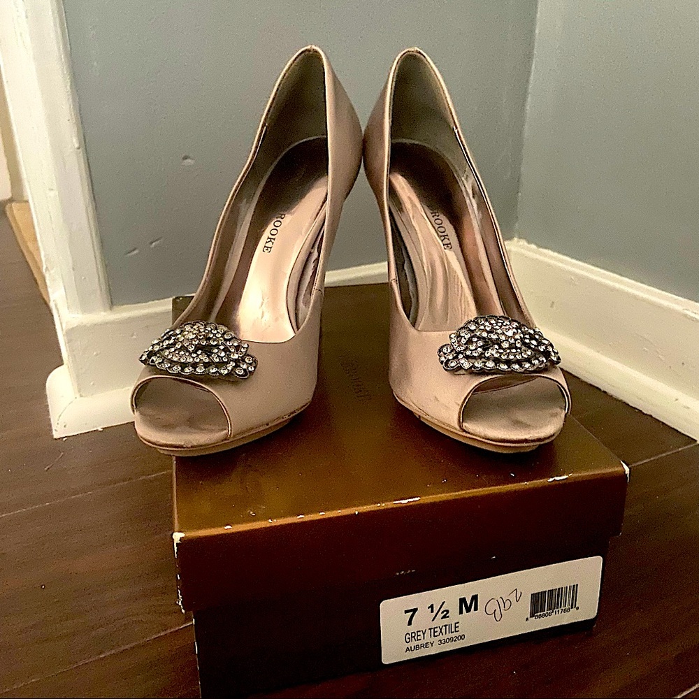 Grey satin peep toe pump.